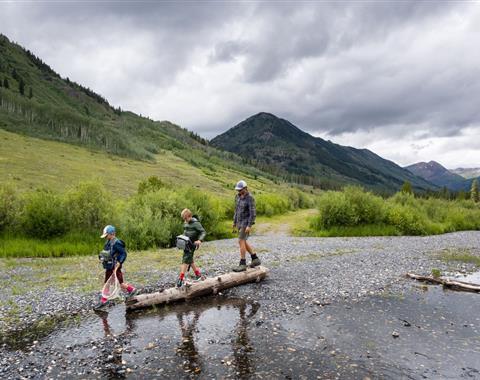 Family hiking along a river path together