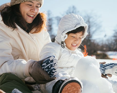 Family building a snowman