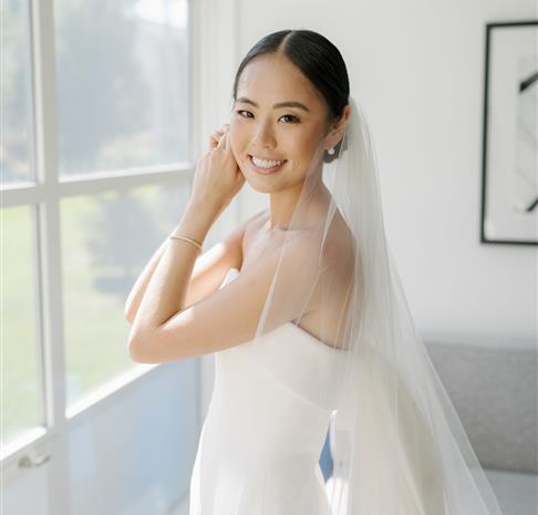 a bride standing in the window