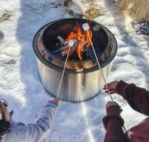 Children roasting marshmallows at a firepit
