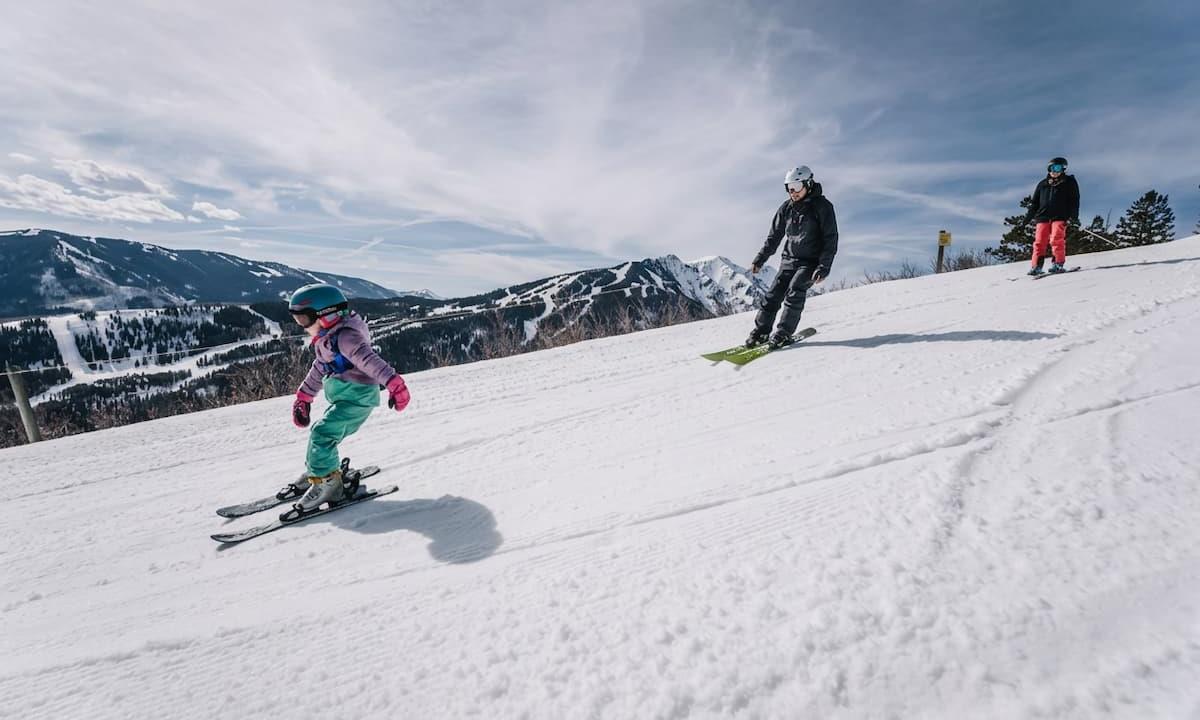 Family skiing down the mountain 