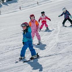  Children learning the art of skiing on the snow-covered hill