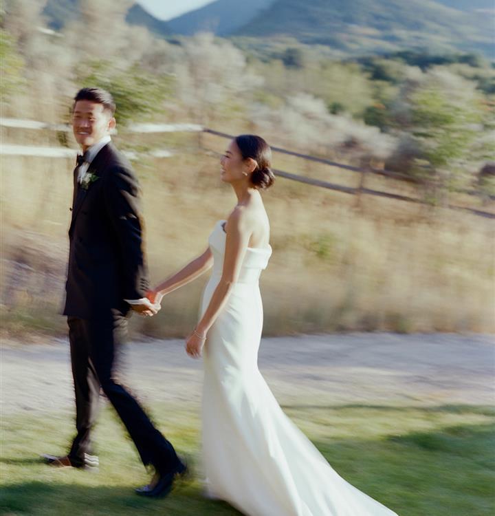 Couple walking at outdoor wedding celebration