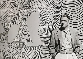 Herbert Bayer in front of a line mural