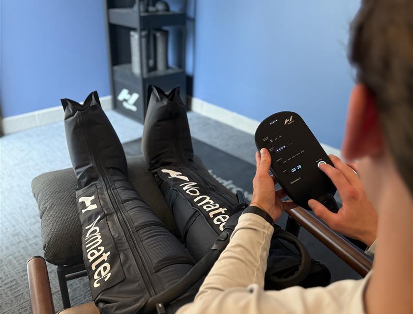 Man in Normatec suit