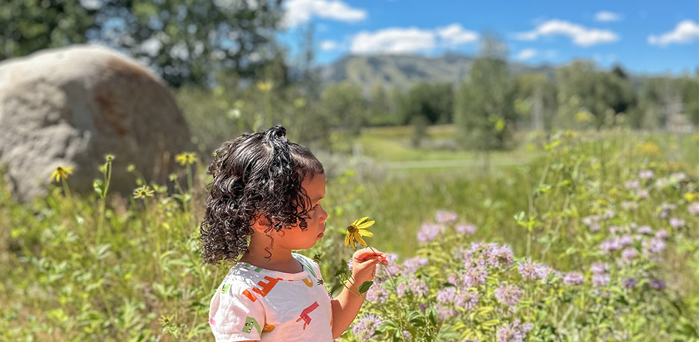 a young girl enjoying the blooming flowers in spring