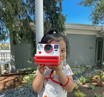 child with polaroid camera