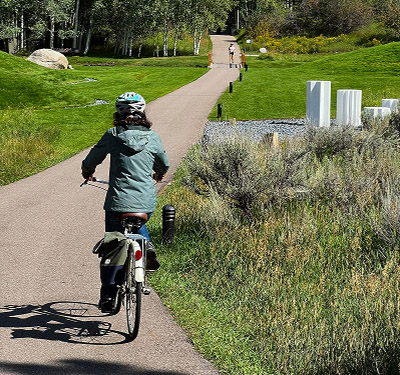 Person riding bike along a trail
