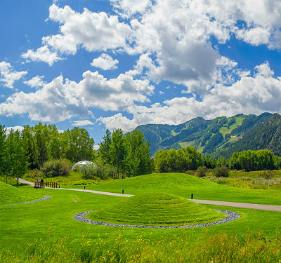 Green meadows with blue skies and fluffy clouds