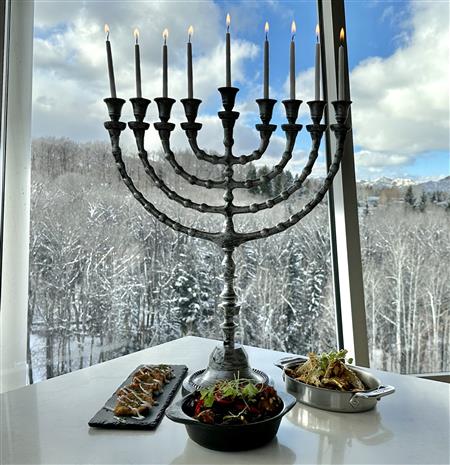 Menorah candle in front of mountains