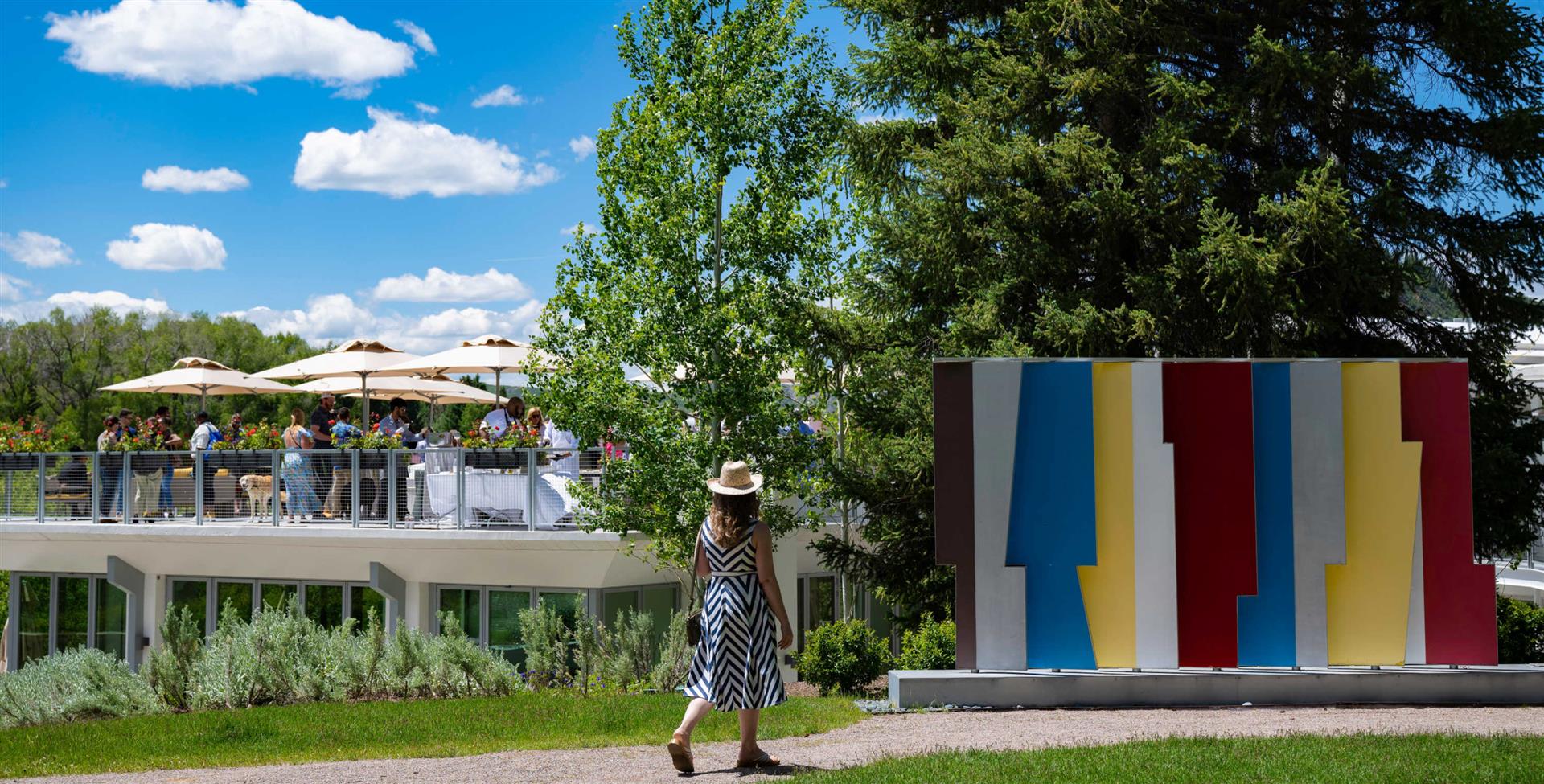 A woman engrossed in observing an outdoor art sculpture