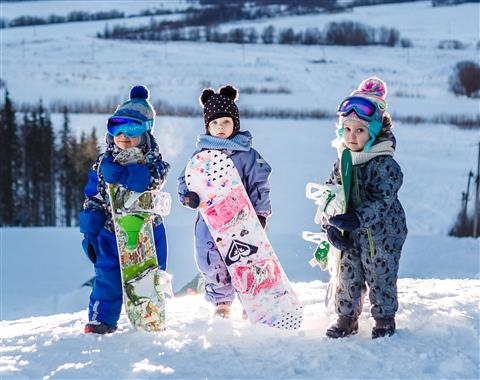 little kids with snowboards