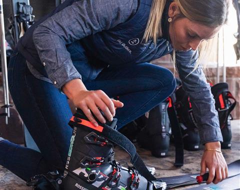woman preparing skis