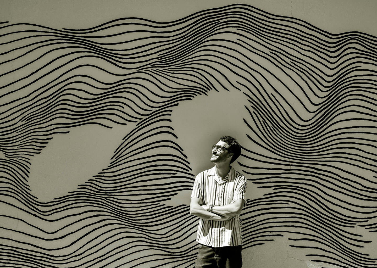 Man standing in front of line mural