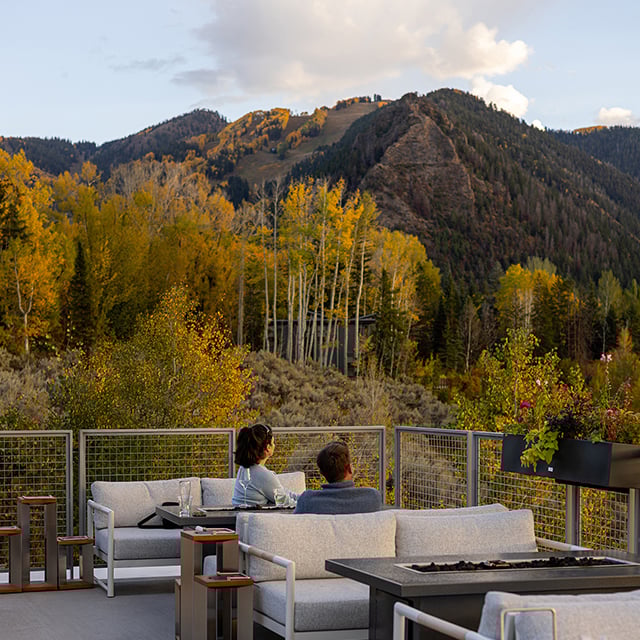 Couple enjoys the fall mountain views from West End Social Patio